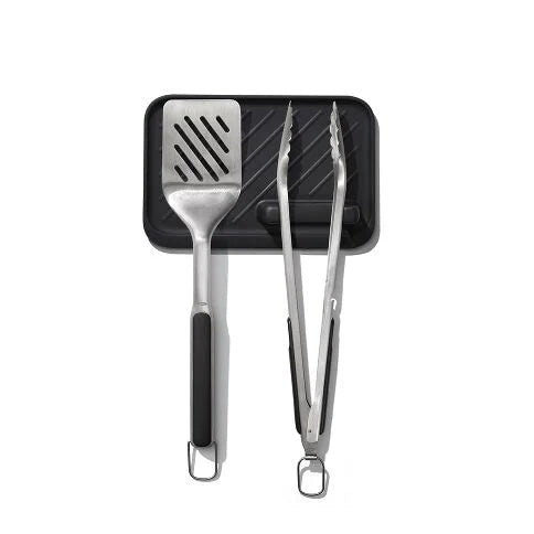 Elevate your grilling experience with the OXO Good Grips 3-Piece Grilling Tool Set, essential for grillers of all skill levels. This thoughtfully designed collection includes scalloped-edge Tongs with an integrated bottle opener for convenient refreshments, a Turner with a double-bend design for superior leverage when flipping heavy foods, and an innovative Tool Rest that provides a heat-resistant surface with a specialized tong holder for one-handed operation.