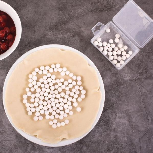 Mrs. Anderson's Ceramic Pie Weights keep empty pie shells from shrinking, bubbling, and buckling during the blind baking process in a pie dough