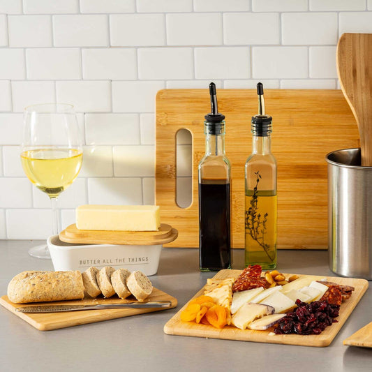 Crafted from durable bamboo, its natural wood tones offer a sleek, modern look while providing a sturdy surface for chopping, slicing, and dicing. Perfect for everyday meal prep or serving cheeses and crudités, this board combines functionality with timeless elegance.