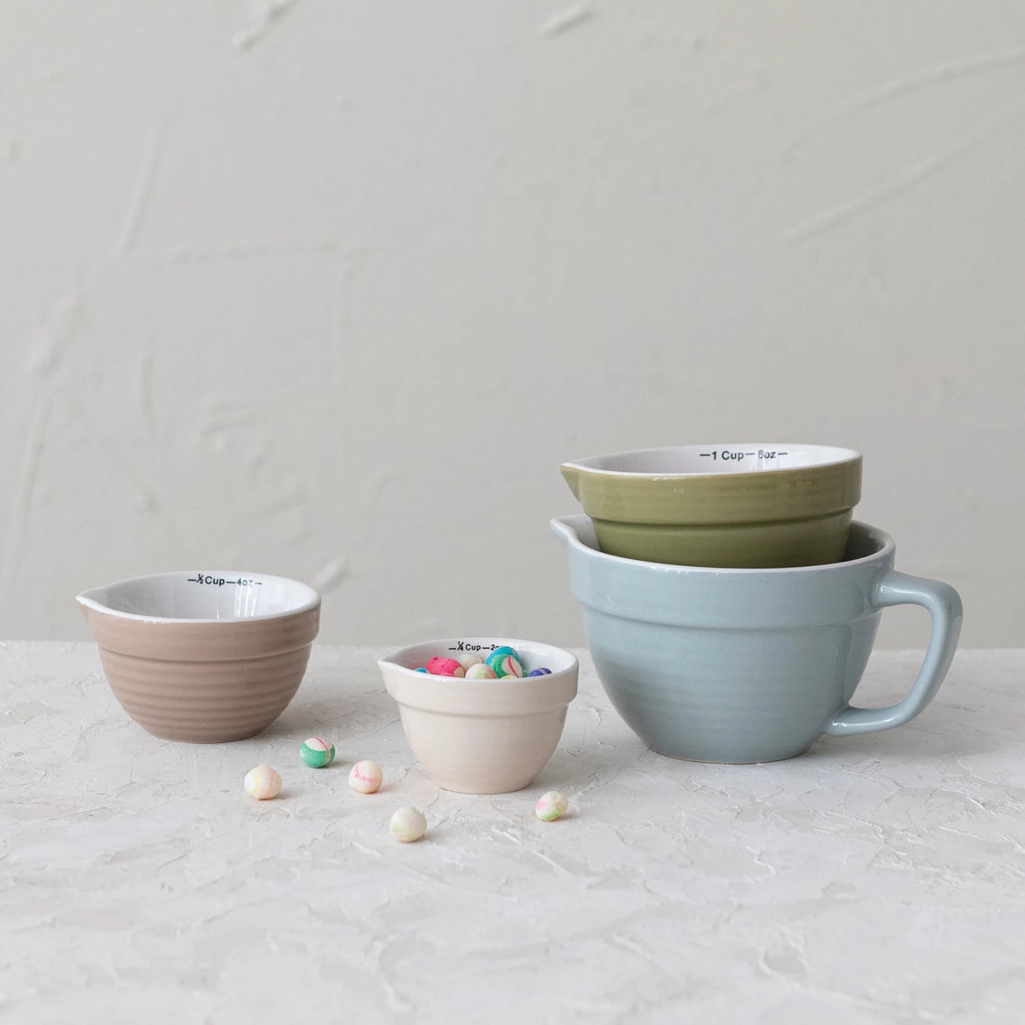 Add charm and functionality to your kitchen with this Set of 4 Batter Bowl Measuring Cups, crafted from durable stoneware in a variety of versatile hues. Designed to resemble classic batter bowls, each cup features an easy-pour spout and a sturdy handle for effortless measuring and pouring of wet or dry ingredients.