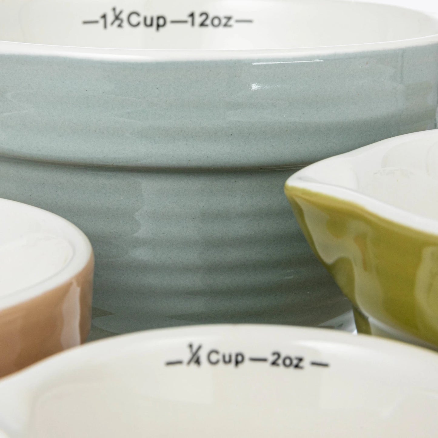 Add charm and functionality to your kitchen with this Set of 4 Batter Bowl Measuring Cups, crafted from durable stoneware in a variety of versatile hues. Designed to resemble classic batter bowls, each cup features an easy-pour spout and a sturdy handle for effortless measuring and pouring of wet or dry ingredients.