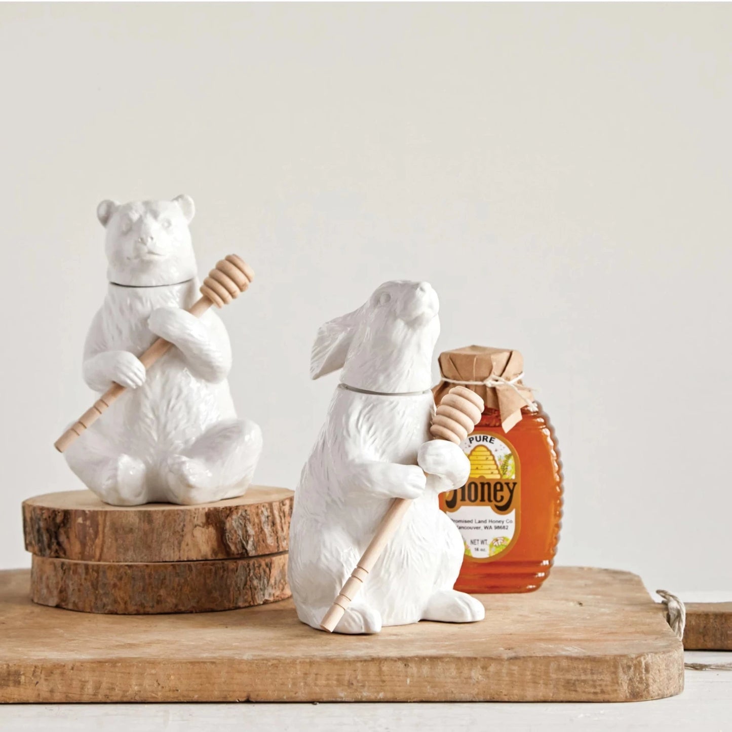 Honey should be served in this white bear shaped pot. Our friendly bear is holding the bamboo dipper until it is needed again. This honey pot can be left out in the kitchen as part of its decor.