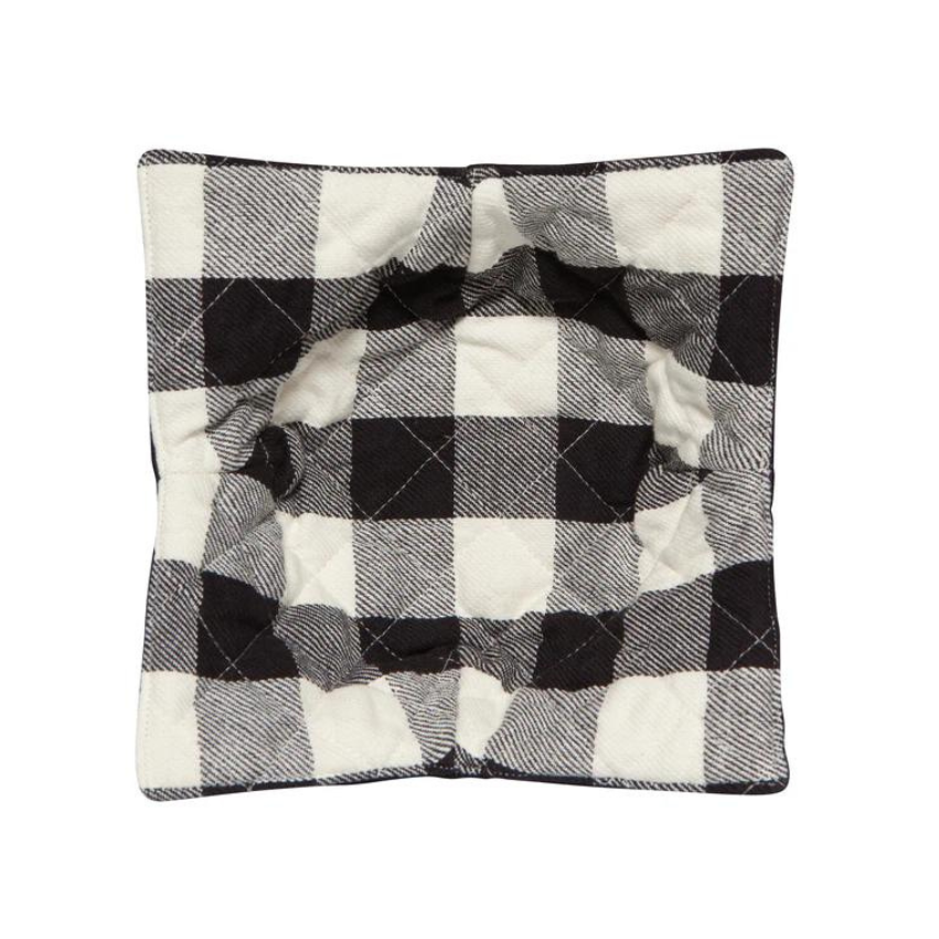 A quilted bowl cozy in black with a white plaid print, designed to provide a comfortable grip for hot bowls.