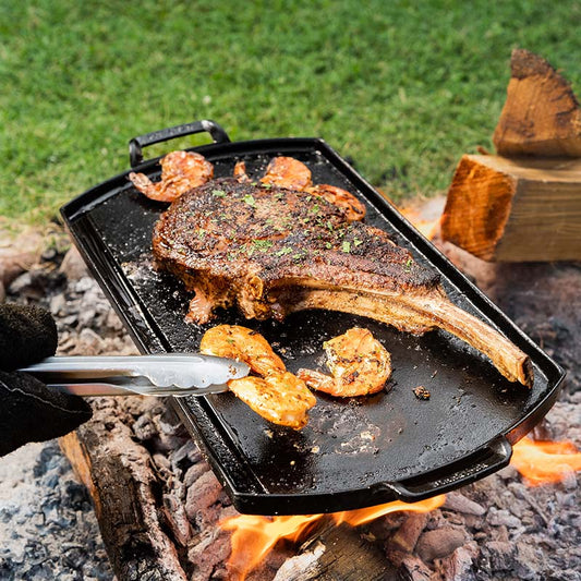 Celebrate history and craftsmanship with this versatile, triple seasoned™ cast iron double burner griddle, honoring two pivotal moments in our legacy. Designed for exceptional performance, it features a natural nonstick finish, a thin yet durable cast, and elevated handles for comfort and control.