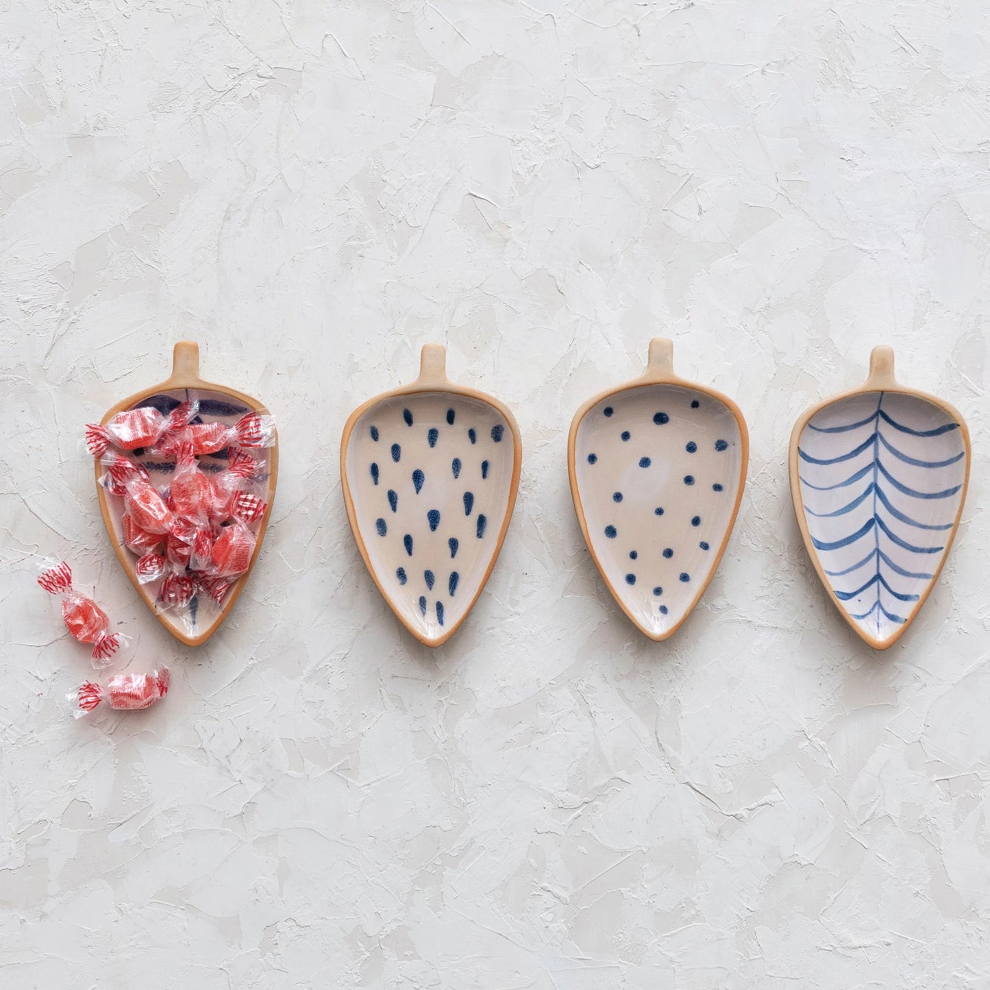 This cottage-inspired stoneware dish showcases the silhouette of a leaf. Available in 4 styles of intricately hand-painted designs.