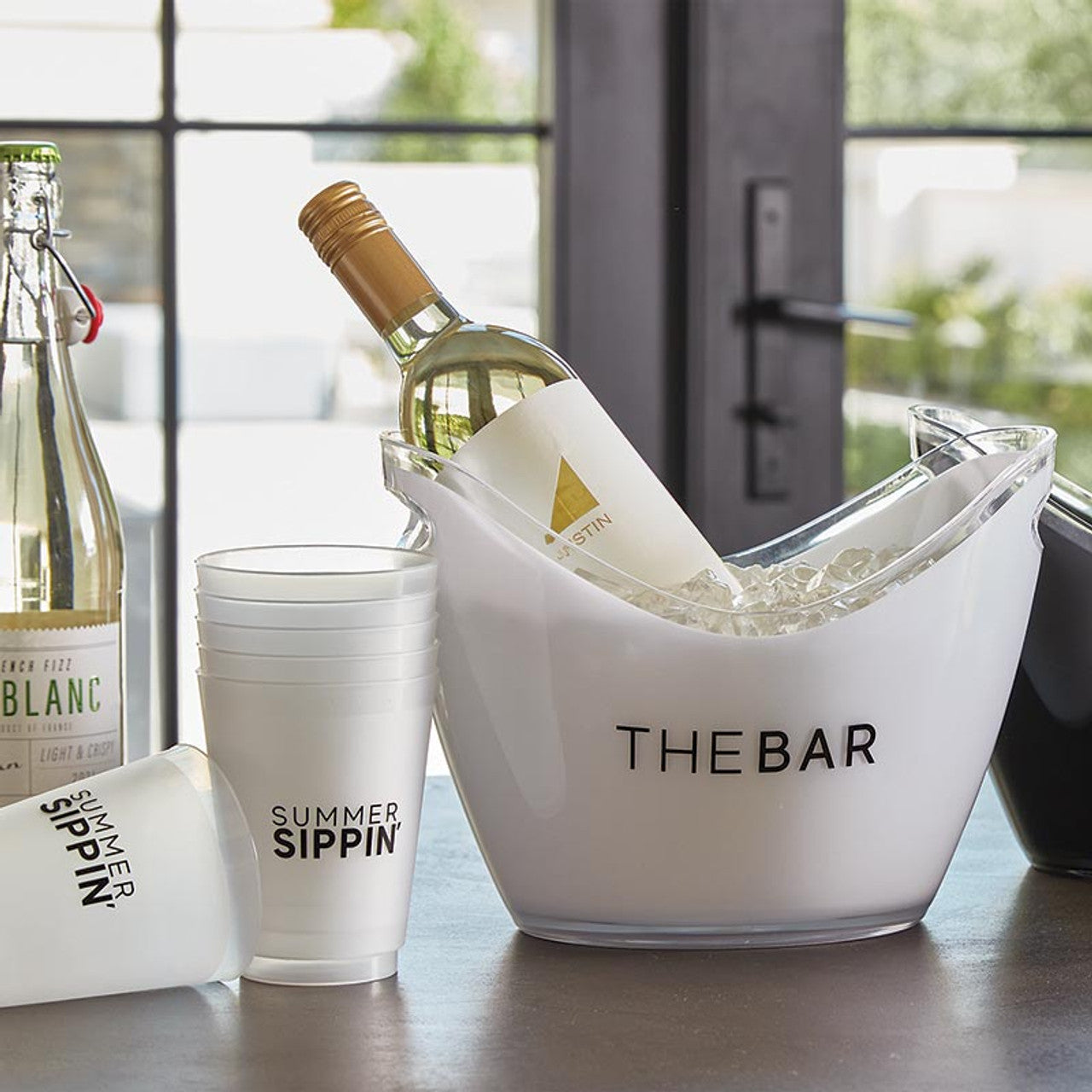 Prepare for your next party in style with our acrylic ice buckets, featuring "The Bar" boldly displayed. Crafted from durable acrylic, these buckets include convenient cut-out handles for easy transport, whether you're serving guests indoors or enjoying outdoor dining. The scooped rim design ensures effortless access to your favorite beverages, making it a must-have for any gathering.