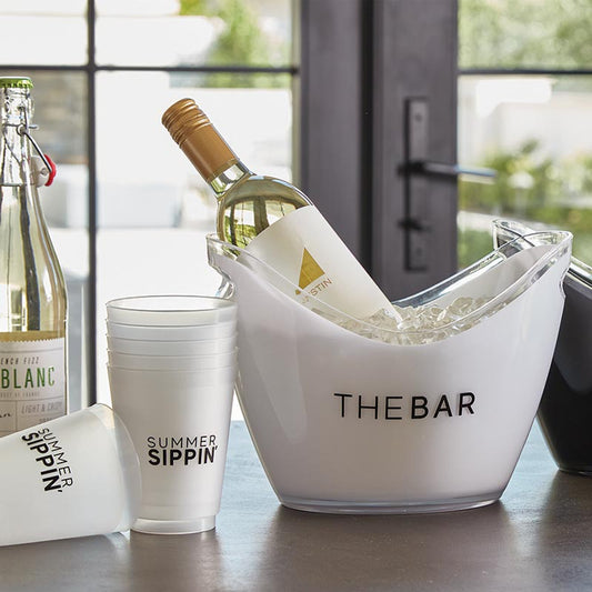 Prepare for your next party in style with our acrylic ice buckets, featuring "The Bar" boldly displayed. Crafted from durable acrylic, these buckets include convenient cut-out handles for easy transport, whether you're serving guests indoors or enjoying outdoor dining. The scooped rim design ensures effortless access to your favorite beverages, making it a must-have for any gathering.