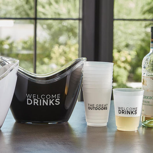 Get ready for your next party with our acrylic ice buckets, adorned with "Welcome Drinks" for a touch of hospitality. Constructed from durable acrylic, these buckets feature practical cut-out handles for effortless mobility, perfect for both indoor and outdoor dining settings. The scooped rim design allows for easy access to refreshments, making it a delightful addition to your entertaining essentials.