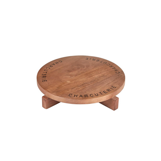 Crafted from mango wood with a stylish footed base and the word "charcuterie" elegantly etched around the top. This board is not just a serving piece but a statement of culinary sophistication. Perfect for presenting an assortment of cheeses, cured meats, fruits, and nuts, it adds a touch of rustic charm to any dining occasion. Ideal for entertaining or everyday use, this versatile board enhances your table setting with its natural beauty and practical design.
