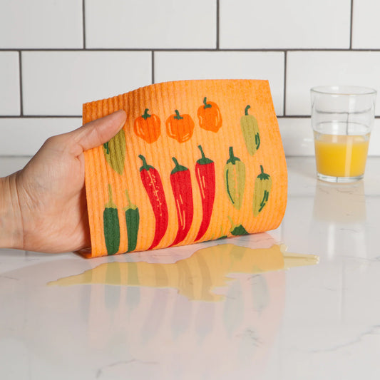 Spice up your favorite culinary creation with this Chili Peppers Swedish dishcloth by Ecologie.