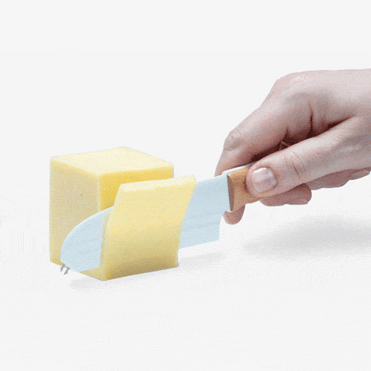 Knibble: the versatile non-stick cheese knife that slices, spreads, and serves nibbles with ease. Its unique barbed blade creates air pockets to prevent cheese from sticking. Stainless steel forks align perfectly with the blade for safe serving. The rounded top edge allows smooth spreading and scraping without scratching. Durable, sharp forks and plastic blade resist rust for the ultimate cheese experience.