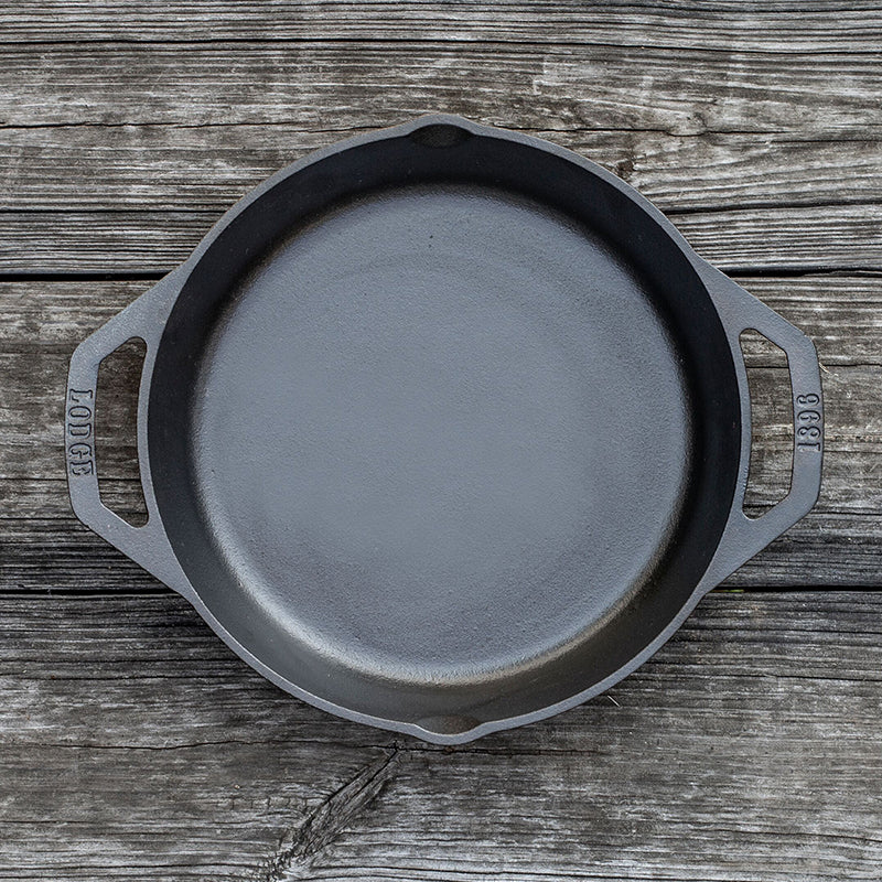 this dual-handle skillet is a kitchen essential designed for versatility and ease. Its naturally seasoned surface, ready to use, ensures easy food release while providing excellent heat distribution and retention for consistent, even cooking.