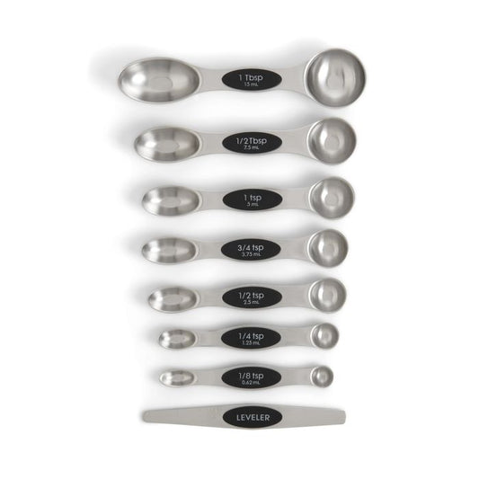 Set of stainless steel measuring spoons with black labels on a white background