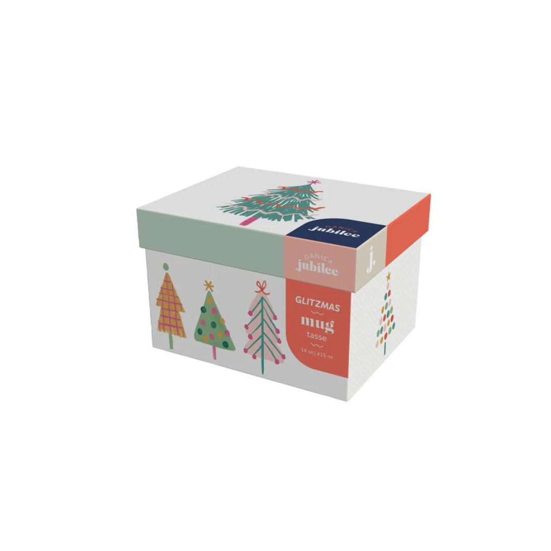 he Mug in a Box - Glitzmas from Danica Jubilee! This festive set invites you to sip in style with a stunning ceramic mug nestled in a gift-ready box. Adorned with dazzling holiday designs, this 14-ounce stoneware mug brings a touch of glitter to your holiday cheer, whether you're enjoying a cozy cocoa or a festive coffee.