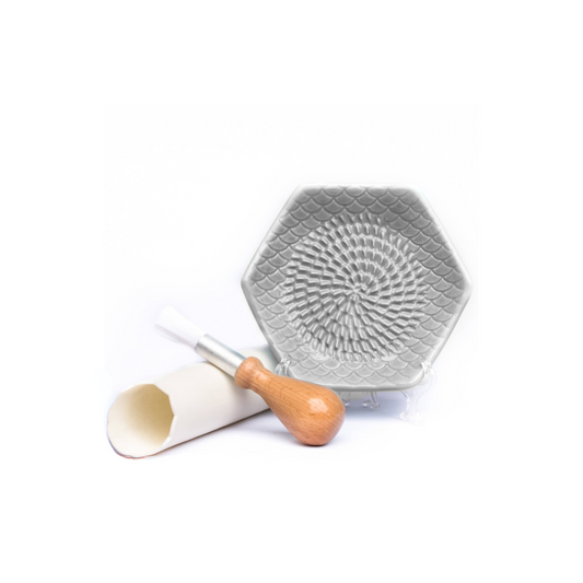 The Grate Plate is a ceramic grating plate used to grate garlic, ginger, peppers, nutmeg, chocolate, hard cheeses and much more! Perfect for adding fresh flavor to any dish. It's easy to clean and can be reused for an endless variety of culinary creations. Plus, the handy silicone garlic peeler and gathering brush make prepping fast and mess-free!