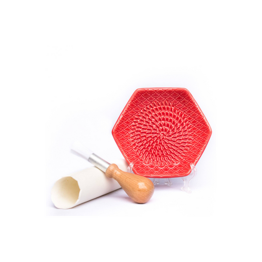The Grate Plate is a ceramic grating plate used to grate garlic, ginger, peppers, nutmeg, chocolate, hard cheeses and much more! Perfect for adding fresh flavor to any dish. It's easy to clean and can be reused for an endless variety of culinary creations. Plus, the handy silicone garlic peeler and gathering brush make prepping fast and mess-free!