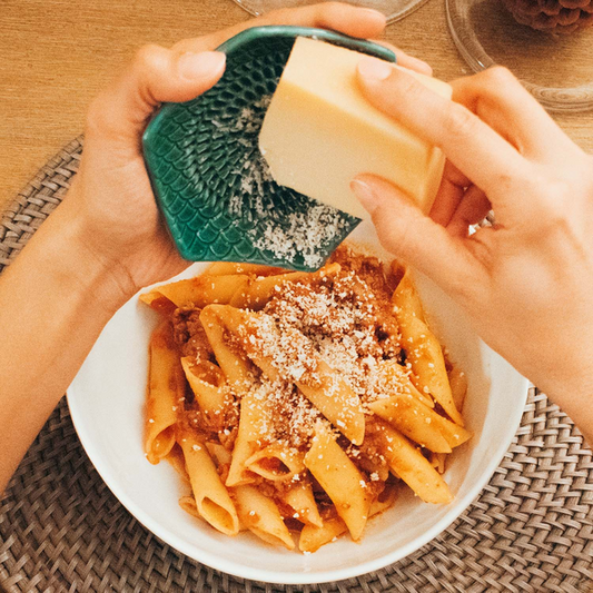 The Grate Plate is a ceramic grating plate used to grate garlic, ginger, peppers, nutmeg, chocolate, hard cheeses and much more! Perfect for adding fresh flavor to any dish. It's easy to clean and can be reused for an endless variety of culinary creations. Plus, the handy silicone garlic peeler and gathering brush make prepping fast and mess-free!