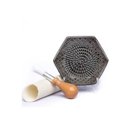 The Grate Plate is a ceramic grating plate used to grate garlic, ginger, peppers, nutmeg, chocolate, hard cheeses and much more! Perfect for adding fresh flavor to any dish. It's easy to clean and can be reused for an endless variety of culinary creations. Plus, the handy silicone garlic peeler and gathering brush make prepping fast and mess-free!