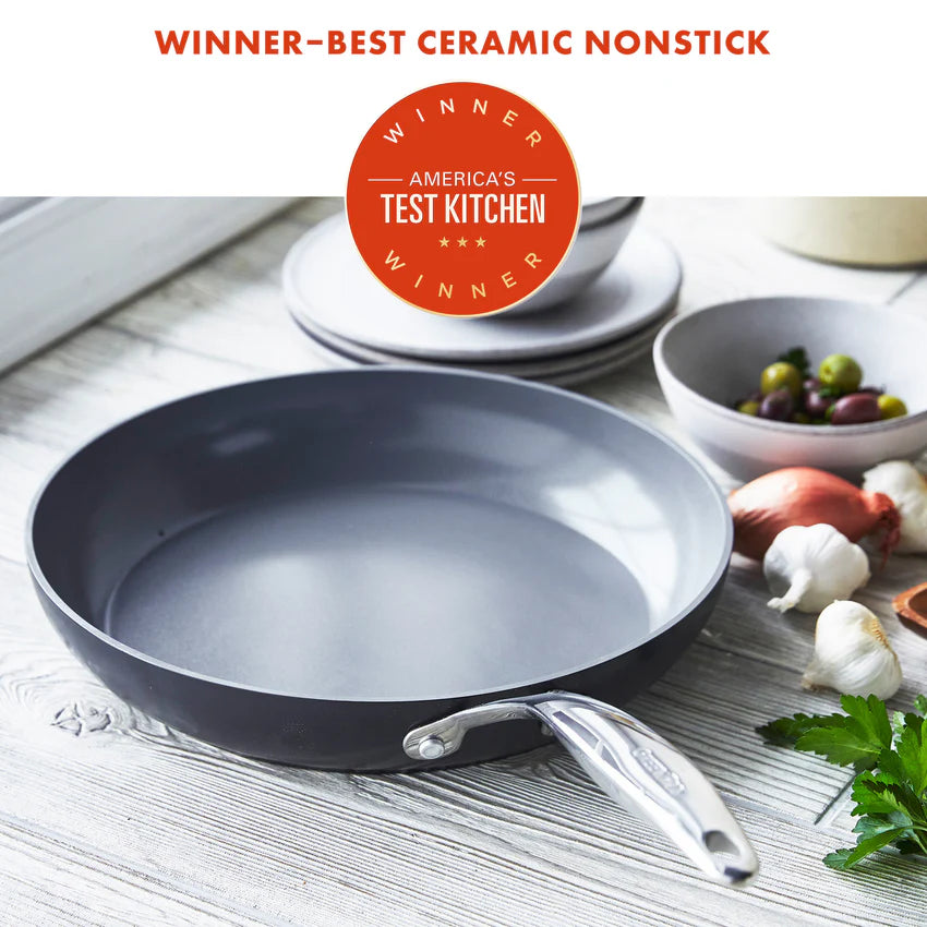 Ceramic nonstick frying pan on a wooden surface with 'America's Test Kitchen' award badge.