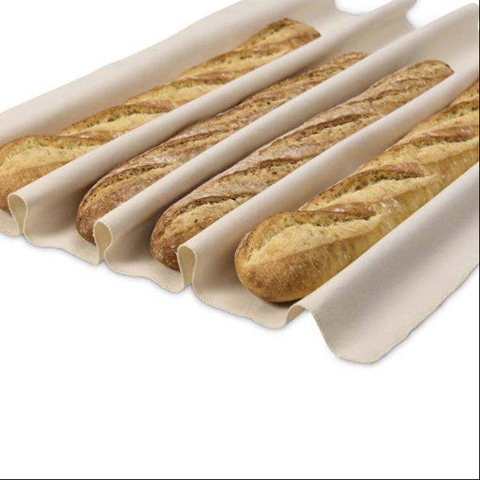 Baguettes on a silicone baking mat with a white background