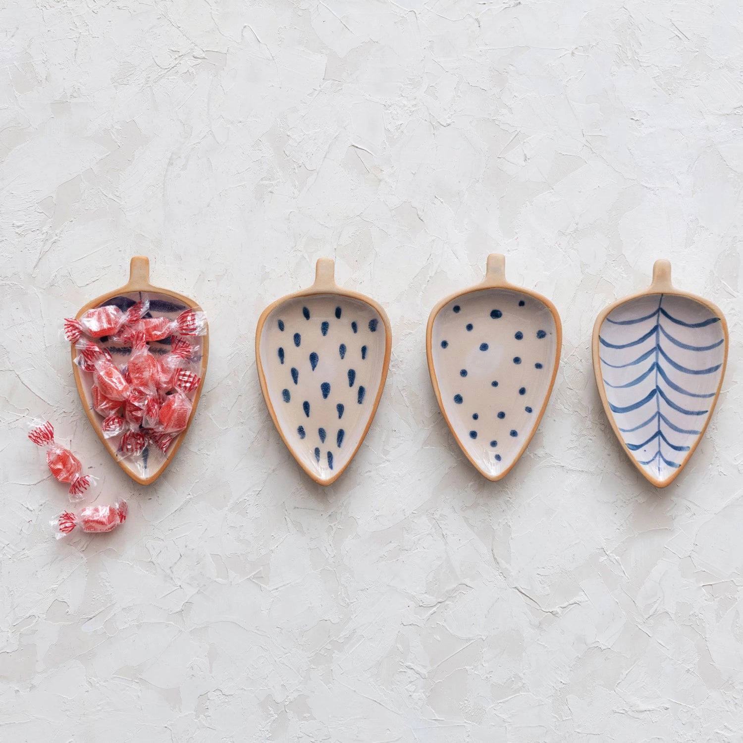 This cottage-inspired stoneware dish showcases the silhouette of a leaf. Available in 4 styles of intricately hand-painted designs.