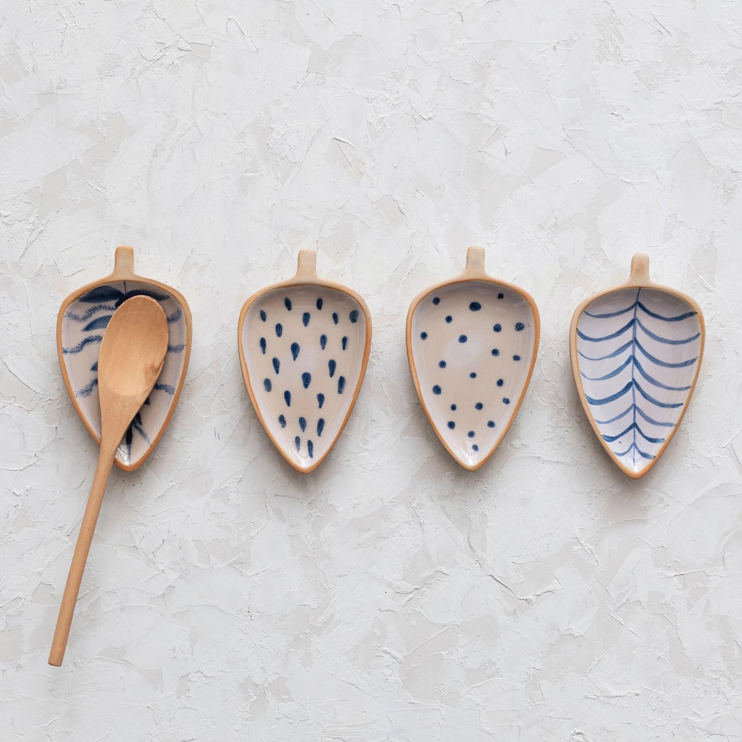 This cottage-inspired stoneware dish showcases the silhouette of a leaf. Available in 4 styles of intricately hand-painted designs.