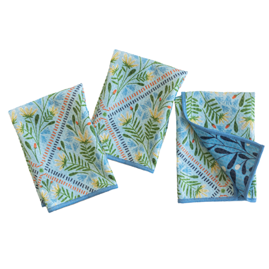 Set of three floral-patterned napkins on a white background