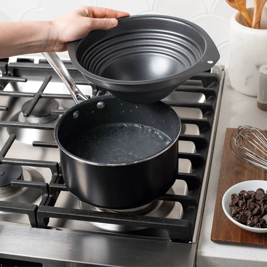 Double Boiler being placed on pot and chocolate added then melted and stirred