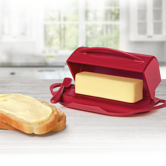 red butter dish on counter with butter and bread