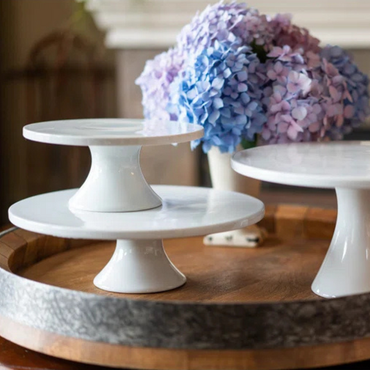Elevate your table setting with the BIA Cordon Bleu Porcelain Round Tall Cake Stand in classic white design. This stand is perfect for showcasing your delicious baked creations with its clean lines and simple shape. Ideal for both casual and fine dining, as well as buffet-style entertaining or special occasions.