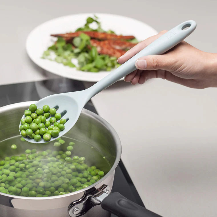 The Silicone Slotted Spoon in Coastal Blue is the ultimate multitasker for your kitchen! Perfect for stirring, straining, and serving, its sculpted head makes cooking effortless. The sturdy nylon core is wrapped in high-quality, non-scratch silicone, keeping your cookware safe while handling high heat up to 482ºF.