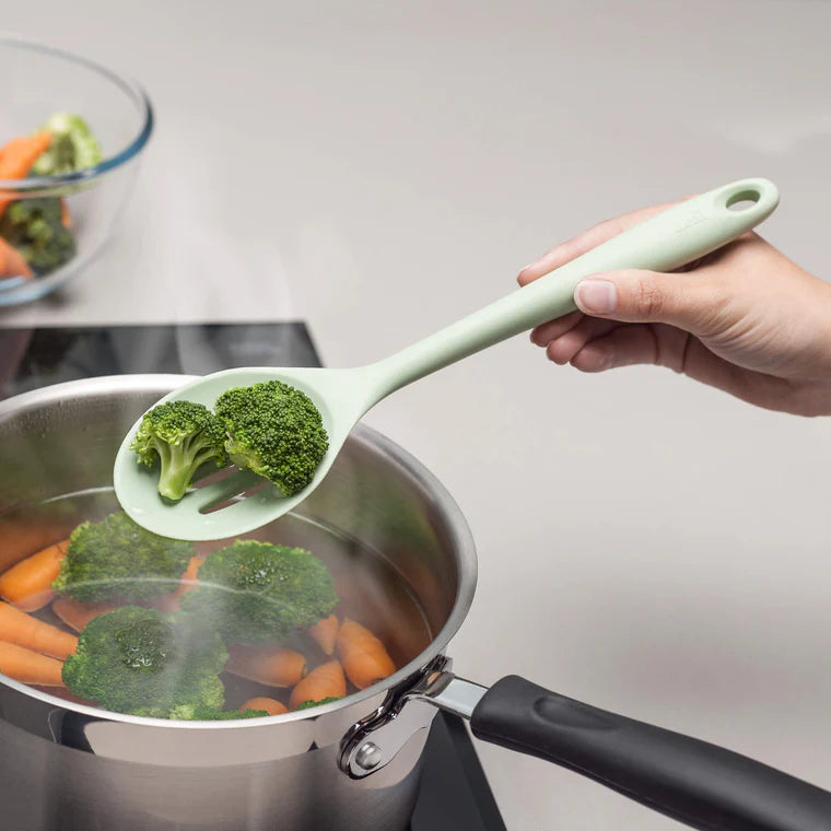 The Silicone Slotted Spoon in Coastal Green is the ultimate multitasker for your kitchen! Perfect for stirring, straining, and serving, its sculpted head makes cooking effortless. The sturdy nylon core is wrapped in high-quality, non-scratch silicone, keeping your cookware safe while handling high heat up to 482ºF.