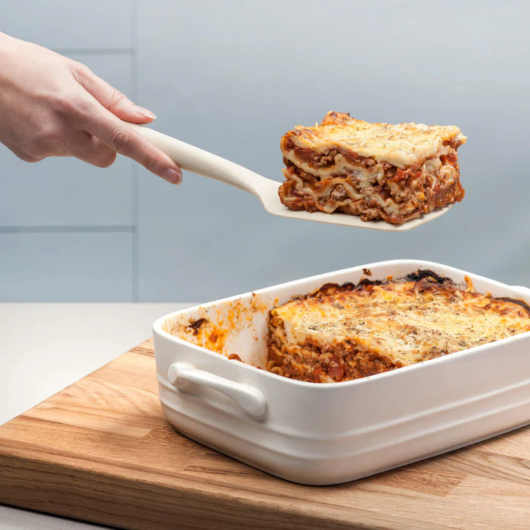 Flip, lift, and serve with ease using the Zeal Silicone Slotted Turner in Coastal Green! Designed with a flexible steel core and a wide, tapered head, this turner makes handling delicate foods—like omelets, crepes, and flaky fish—a breeze.