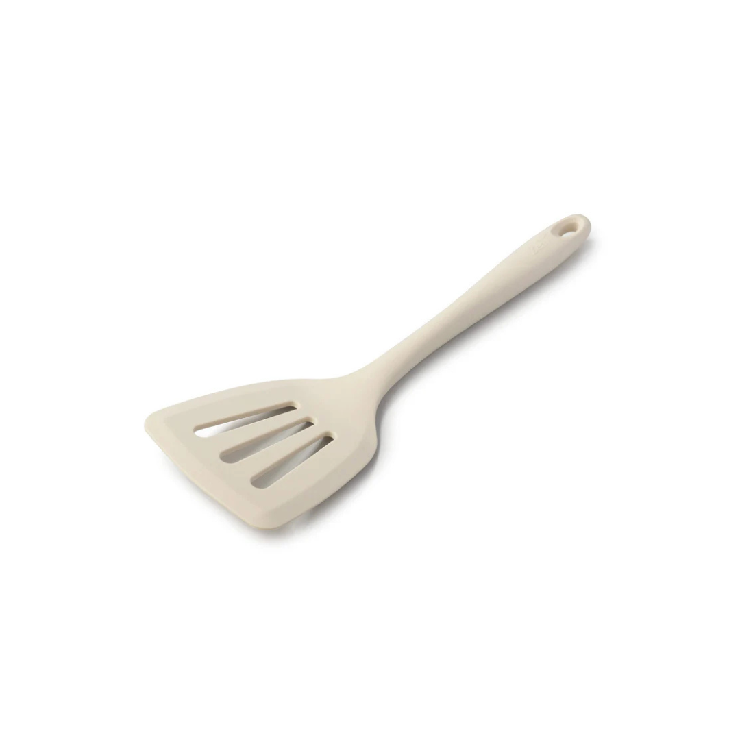 Flip, lift, and serve with ease using the Zeal Silicone Slotted Turner in Coastal Green! Designed with a flexible steel core and a wide, tapered head, this turner makes handling delicate foods—like omelets, crepes, and flaky fish—a breeze.