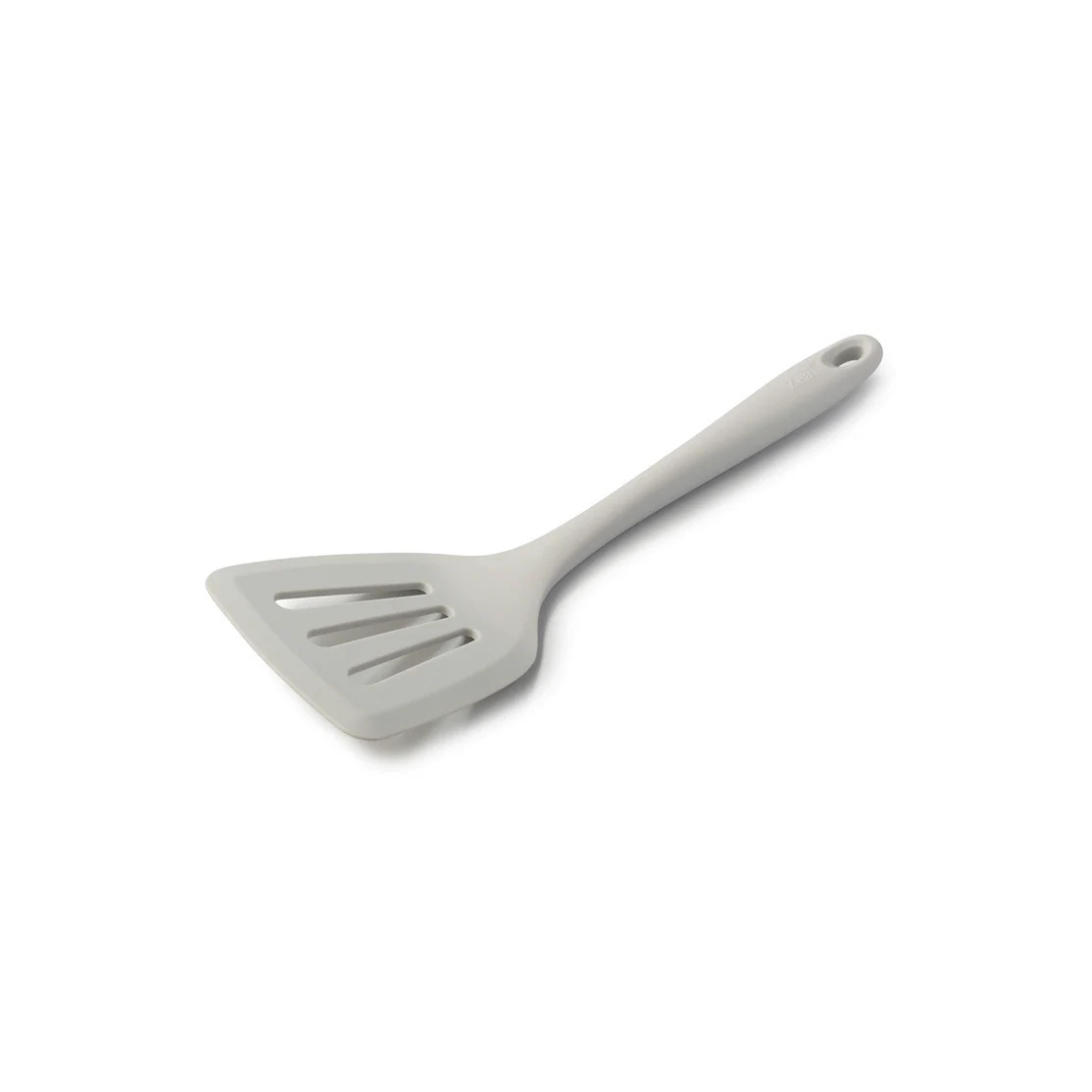 Flip, lift, and serve with ease using the Zeal Silicone Slotted Turner in Coastal Grey! Designed with a flexible steel core and a wide, tapered head, this turner makes handling delicate foods—like omelets, crepes, and flaky fish—a breeze.