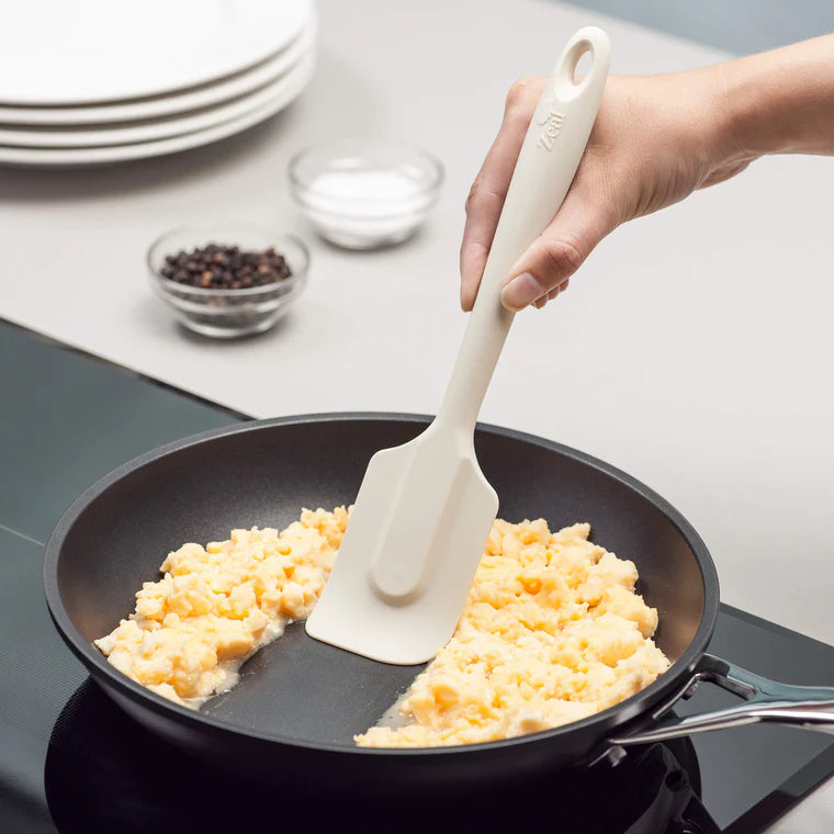 The 10" Coastal Cream Silicone Spatula by Zeal is your go-to kitchen sidekick for stirring, scraping, mixing, and baking with ease. Designed with an ergonomic handle and a handy hanging loop for effortless storage, this spatula features a flexible yet durable non-scratch silicone head that’s safe for all non-stick surfaces.