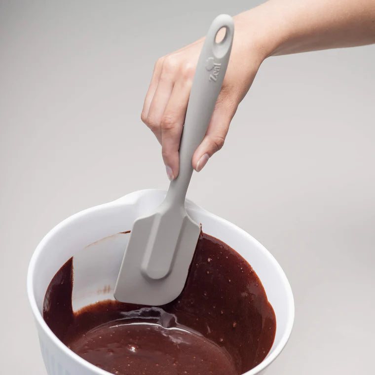 The 10" Coastal Grey Silicone Spatula by Zeal is your go-to kitchen sidekick for stirring, scraping, mixing, and baking with ease. Designed with an ergonomic handle and a handy hanging loop for effortless storage, this spatula features a flexible yet durable non-scratch silicone head that’s safe for all non-stick surfaces.