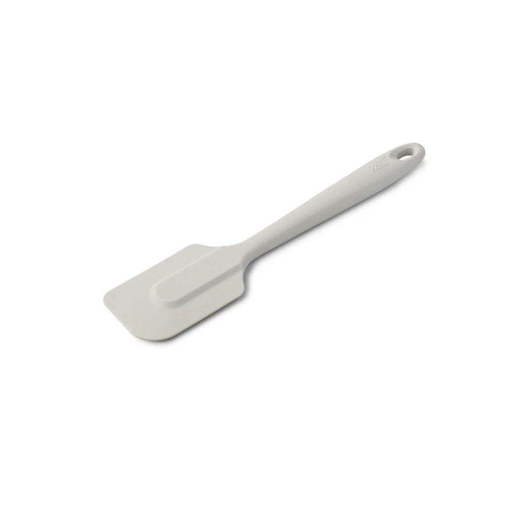 The 10" Coastal Grey Silicone Spatula by Zeal is your go-to kitchen sidekick for stirring, scraping, mixing, and baking with ease. Designed with an ergonomic handle and a handy hanging loop for effortless storage, this spatula features a flexible yet durable non-scratch silicone head that’s safe for all non-stick surfaces.