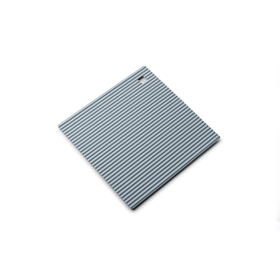 The Zeal Silicone Trivet Mat is the ultimate kitchen multitasker, protecting your countertops and tables from hot pots, pans, and dishes with its non-slip, heat-resistant design (up to 250ºC/482ºF). This 9" x 9" mat isn’t just for hot cookware—it doubles as a potholder, placemat, jar opener, or even a stabilizer for mixing bowls and cutting boards.
