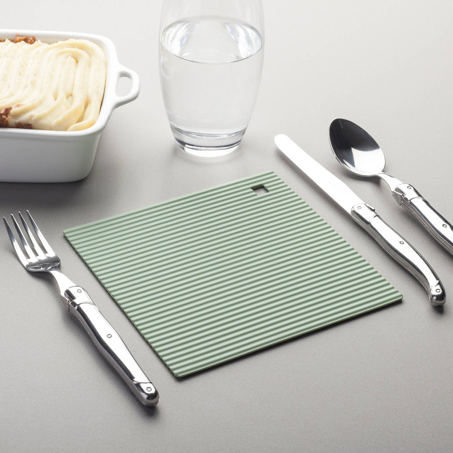 The Zeal Silicone Trivet Mat is the ultimate kitchen multitasker, protecting your countertops and tables from hot pots, pans, and dishes with its non-slip, heat-resistant design (up to 250ºC/482ºF). This 9" x 9" mat isn’t just for hot cookware—it doubles as a potholder, placemat, jar opener, or even a stabilizer for mixing bowls and cutting boards.