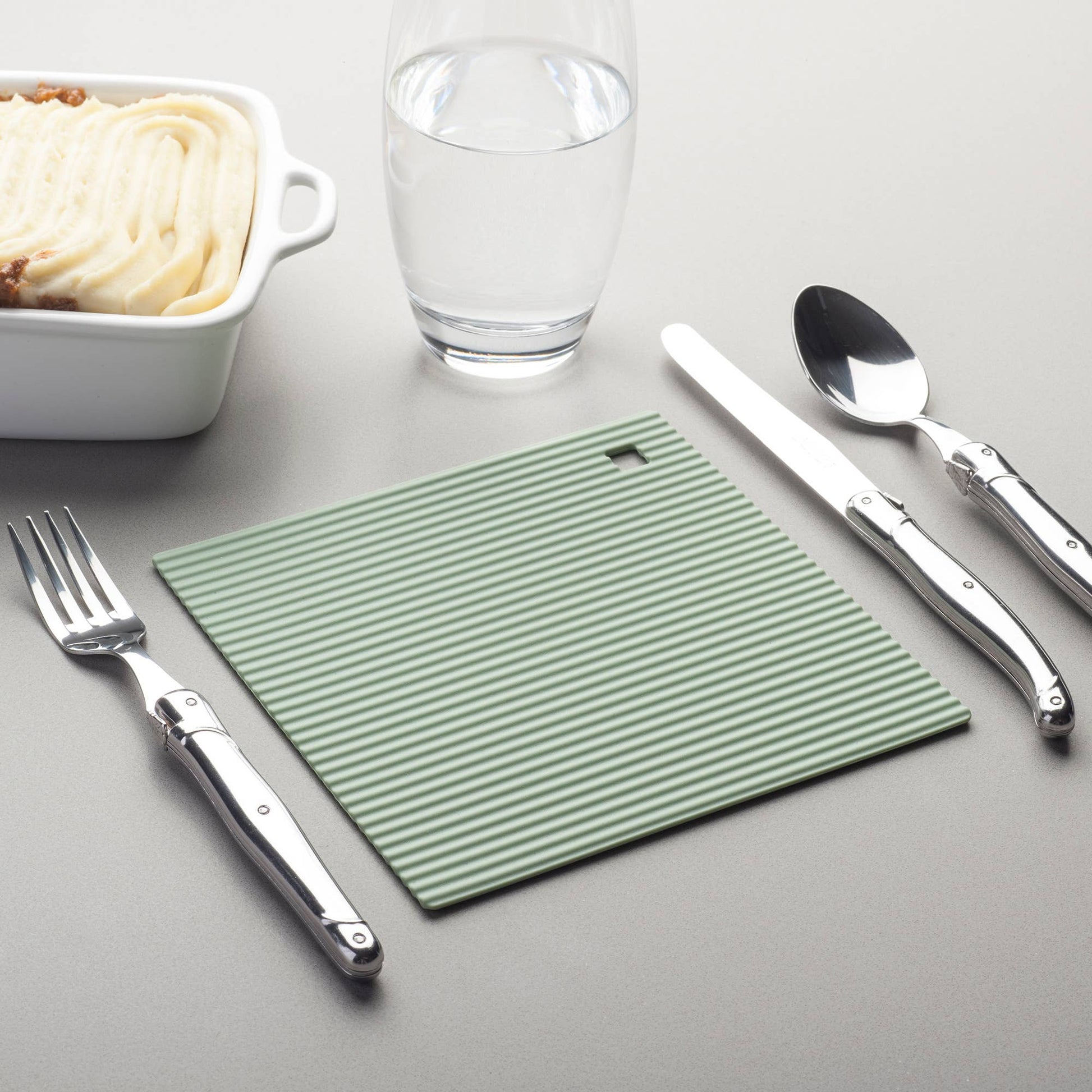 The Zeal Silicone Trivet Mat is the ultimate kitchen multitasker, protecting your countertops and tables from hot pots, pans, and dishes with its non-slip, heat-resistant design (up to 250ºC/482ºF). This 9" x 9" mat isn’t just for hot cookware—it doubles as a potholder, placemat, jar opener, or even a stabilizer for mixing bowls and cutting boards.