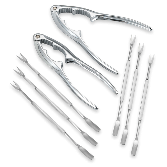 Set of silver kitchen tools including tongs and prongs on a white background