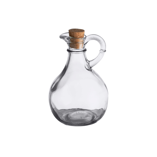 Clear glass carafe with cork stopper on white background