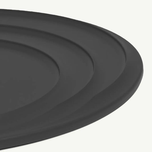 Made In Universal Frying Pan Lid in Grey! Designed to fit every size of Made In Stainless Steel, Carbon Steel, and Non Stick Frying Pans—plus the Made In Wok—this sleek, all-in-one solution helps you simmer, fry, and keep food warm with ease. Crafted with a durable stainless steel interior and a silicone exterior, it grips securely onto your pan while doubling as a trivet to protect your counters.