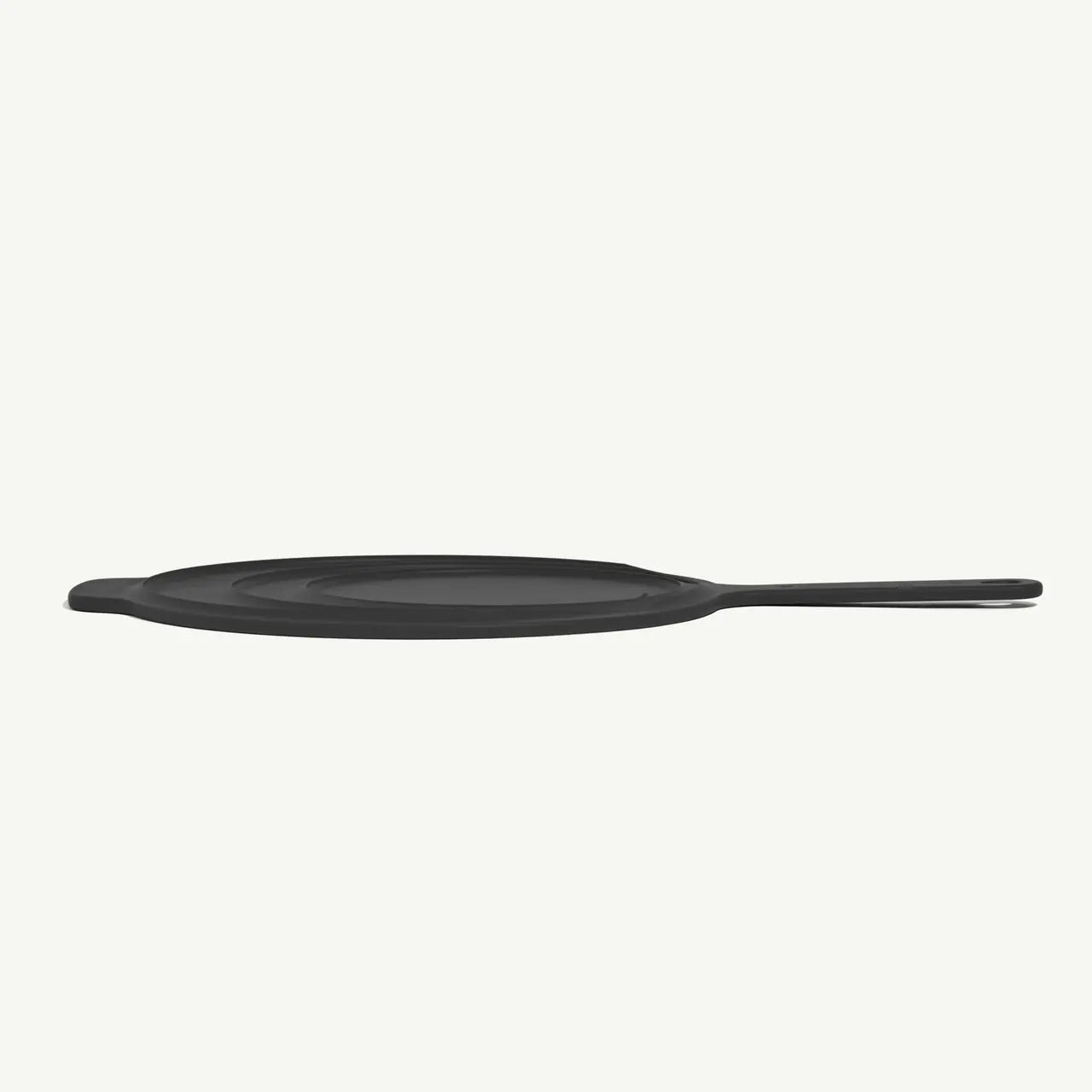 Made In Universal Frying Pan Lid in Grey! Designed to fit every size of Made In Stainless Steel, Carbon Steel, and Non Stick Frying Pans—plus the Made In Wok—this sleek, all-in-one solution helps you simmer, fry, and keep food warm with ease. Crafted with a durable stainless steel interior and a silicone exterior, it grips securely onto your pan while doubling as a trivet to protect your counters.