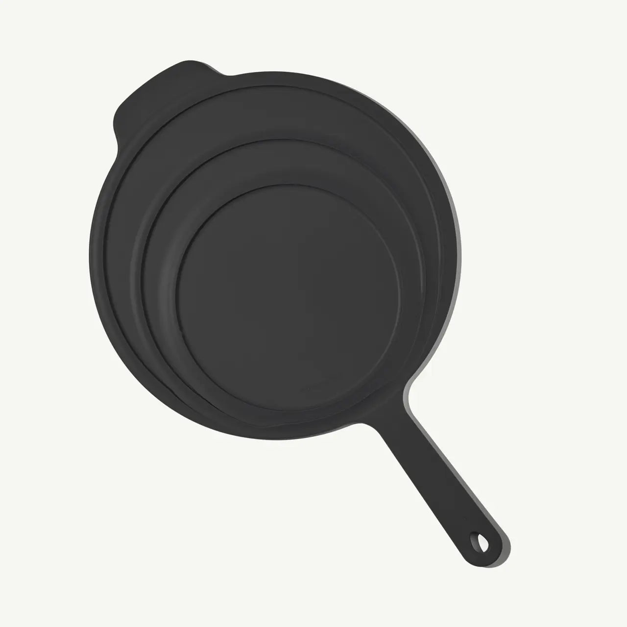 Made In Universal Frying Pan Lid in Grey! Designed to fit every size of Made In Stainless Steel, Carbon Steel, and Non Stick Frying Pans—plus the Made In Wok—this sleek, all-in-one solution helps you simmer, fry, and keep food warm with ease. Crafted with a durable stainless steel interior and a silicone exterior, it grips securely onto your pan while doubling as a trivet to protect your counters.