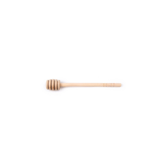 A wooden honey dipper with traditional grooves, used for drizzling honey.