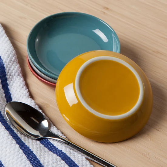 Add a pop of color to your table with the Canyon Dipping Dishes, a set of four stackable stoneware bowls in bold yellow, blue, grey, and red hues. Perfect for serving dips, nuts, candies, and more, these versatile dishes are both stylish and functional.