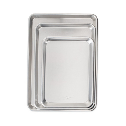 Our top-rated Naturals®Bakeware collection is made of pure aluminum for superior heat conductivity and produces consistent evenly browned baked goods every time. These premium pans have a lifetime durability and will never rust. Encapsulated galvanized steel rims prevent warping. Baker's Delight Set includes one Quarter Sheet, Jelly Roll and Half Sheet Pan for the ultimate set.