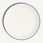 Round white plate with a blue rim on a white background